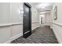 Inviting hallway with decorative wall trim, elegant lighting, and patterned carpet at 2300 Peachford Rd # 1410, Atlanta, GA 30338