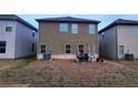 Home's backyard featuring an outdoor seating area and neutral paint at 11700 Brightside Pkwy, Hampton, GA 30228