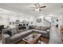 Open concept living room with hardwood floors, a large sofa and view of modern kitchen at 938 Blue Juniper Cir, Loganville, GA 30052