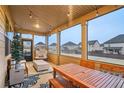 Inviting screened porch with wooden table and chairs, perfect for outdoor dining at 938 Blue Juniper Cir, Loganville, GA 30052