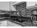 Close up of a black granite countertop and stainless steel microwave at 199 14Th Ne St # 2010, Atlanta, GA 30309