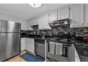 This kitchen features stainless steel appliances, white cabinets, and a sleek backsplash at 199 14Th Ne St # 2010, Atlanta, GA 30309