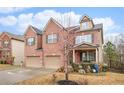 Charming brick home with a two-car garage and a well-maintained lawn on a sunny day at 2656 Muskeg Sw Ct, Atlanta, GA 30331