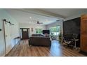 Spacious living room features hardwood floors, a ceiling fan and neutral colors at 4267 Klondike Rd, Lithonia, GA 30038