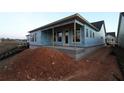 View of the rear of the home with a covered porch and many windows looking out to the backyard at 2017 Ripple Park Bend, Canton, GA 30114