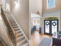 Grand foyer with staircase and double doors to the dining room at 1258 Mcallistar Dr, Locust Grove, GA 30248