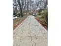 Long concrete driveway leading up to the house with space for multiple vehicles at 2480 Glenbonnie Dr, Dunwoody, GA 30360