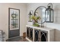 Stylish entryway with decorative mirror, wall decor and wood-look cabinets at 364 Concord St, Alpharetta, GA 30009