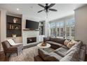 Cozy living room with fireplace, built-in shelving, and ample natural light at 364 Concord St, Alpharetta, GA 30009
