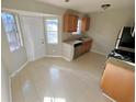 Bright kitchen featuring tile flooring, a window above the sink, and stainless steel appliances at 709 Pine Tree Trl # 10A, Atlanta, GA 30349