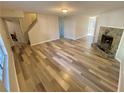 Spacious living room featuring wood-look flooring and a decorative stone fireplace at 709 Pine Tree Trl # 10A, Atlanta, GA 30349