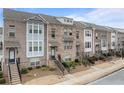 Brick townhomes feature neat landscaping and attractive exteriors with cozy entrances and staircases at 2550 Village Place Dr, Duluth, GA 30096