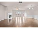 Bright living room boasts a fireplace, hardwood floors, and natural light from large windows at 2550 Village Place Dr, Duluth, GA 30096