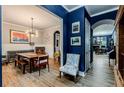 Elegant dining room featuring hardwood floors, wainscoting, and an eye-catching modern chandelier at 3157 Oakdale Rd, Hapeville, GA 30354