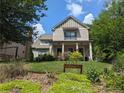 Beautiful two-story home with manicured lawn and charming front porch with decorative address sign at 3157 Oakdale Rd, Hapeville, GA 30354