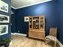 Stylish living room with beautiful hardwood floors and elegant blue walls at 3157 Oakdale Rd, Hapeville, GA 30354