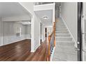 Bright foyer with hardwood floors, staircase, and an open view to the living and dining areas at 4102 Dinmont Chase, Atlanta, GA 30349