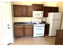 Kitchen features white appliances and wooden cabinets at 3611 Spring Pt, Decatur, GA 30034