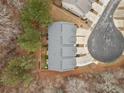 Aerial view of a townhouse showcasing its roof and the surrounding greenery and cul-de-sac at 96 Trailview Lane Ln, Hiram, GA 30141