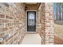 Close-up of the brick entryway, featuring a black front door with glass panels at 96 Trailview Lane Ln, Hiram, GA 30141