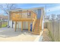 Rear exterior view of the home featuring a wooden deck, staircase and a fenced yard at 1017 Martin Luther King Jr Dr, Atlanta, GA 30314