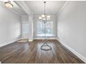 Dining area featuring wood floors, neutral gray walls and a decorative chandelier fixture at 2098 Bridgewater Pass, Hampton, GA 30228