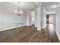 Bright dining room area featuring wood flooring, chandelier lighting, and neutral wall color at 2098 Bridgewater Pass, Hampton, GA 30228