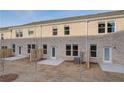 Back view of new townhomes with small patios and newly seeded backyards at 313 Heavenly Hollow Pl, Mcdonough, GA 30253