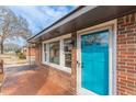 Inviting brick facade with a vibrant blue front door and tiled porch at 4624 College St, Forest Park, GA 30297