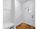 Mud room with hardwood floors, white trim and storage bench at 507 Ridge View Xing, Woodstock, GA 30188