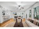 Bright living room area with hardwood floors, white trim, and many windows at 507 Ridge View Xing, Woodstock, GA 30188