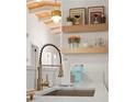 Modern kitchen features a gold faucet, white countertops, and open shelving at 2111 Drew Valley Ne Rd, Brookhaven, GA 30319