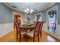 Elegant dining room featuring hardwood floors, detailed trim, and a stylish chandelier at 3496 Honeycomb Dr, Conyers, GA 30094