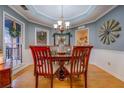 Elegant dining room featuring hardwood floors, detailed trim, and a stylish chandelier at 3496 Honeycomb Dr, Conyers, GA 30094