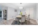 Elegant dining room with wood-look flooring, modern lighting, a round table and four chairs at 6851 Roswell Rd # M12, Sandy Springs, GA 30328