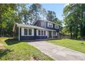 Charming split-level home with a brick accent, a paved driveway and freshly painted trim at 10664 Sandpiper Road Rd, Jonesboro, GA 30238