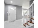 Bright foyer boasts sleek marble tile floors and a staircase with white and wood trim at 10664 Sandpiper Road Rd, Jonesboro, GA 30238
