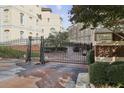 Gated community entrance with brick and metal posts, displaying the community name and address at 3541 Roswell Ne Rd # 23, Atlanta, GA 30305