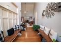 Welcoming foyer with hardwood floors, bench seating, and decorative windmill wall decor at 1030 Silver Thorne Dr, Loganville, GA 30052