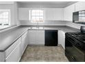 Functional kitchen featuring white cabinets and black appliances at 2341 Wellington Cir, Lithonia, GA 30058