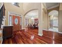 Spacious foyer featuring hardwood floors, an arched doorway, and views into dining room and kitchen at 3591 Lochwolde Ln, Snellville, GA 30039