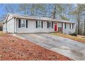 Charming single-story home with gray painted brick, a well-maintained lawn, and a long concrete driveway at 3005 Hidden Dr, Lawrenceville, GA 30044
