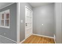 Bright foyer featuring hardwood floors, fresh paint, and a classic white front door at 1495 Harbour Oaks Rd, Tucker, GA 30084