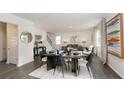 Bright dining area with a table set for six, open to the living area and staircase at 4098 Fairlady Ct, Kennesaw, GA 30144