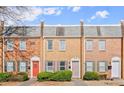 Neat townhouses showing brick facade, stone tile roofs, landscaping, and walkways to the front doors at 265 Winding River Dr # F, Atlanta, GA 30350