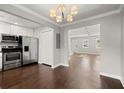 Modern kitchen with stainless steel appliances, white cabinets, and an adjoining dining area, perfect for entertaining at 265 Winding River Dr # F, Atlanta, GA 30350