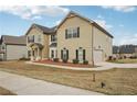 Two-story home with a side-entry garage, tidy landscaping, and neutral-toned exterior at 15 Streamside Dr, Covington, GA 30016