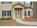 Inviting front entrance featuring stone accents, a covered porch, and a decorative front door at 15 Streamside Dr, Covington, GA 30016