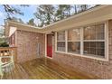 Close up of the front porch with a brick wall and a red front door at 4648 Seward Rd, Powder Springs, GA 30127