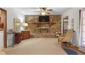 Living room with stone fireplace and a ceiling fan at 4648 Seward Rd, Powder Springs, GA 30127